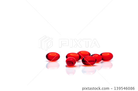 Red soft gel capsule pills isolated on white background. Pile of red soft gelatin capsule. Vitamins and dietary supplements concept. Pharmaceutical industry. Pharmacy drug store. Health care products. Red soft gel capsule pills isolated on white background. Pile of red soft gelatin capsule. Vitamins and dietary supplements concept. Pharmaceutical industry. Pharmacy drug store. Health care products. 139546086
