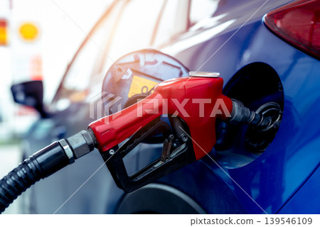 Car fueling at gas station. Refuel fill up with petrol gasoline. Petrol pump filling fuel nozzle in fuel tank of car at gas station. Petrol industry and service. Petrol price and oil crisis concept. Car fueling at gas station. Refuel fill up with petrol gasoline. Petrol pump filling fuel nozzle in fuel tank of car at gas station. Petrol industry and service. Petrol price and oil crisis concept. 139546109