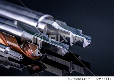 Special tools isolated on dark background. Made to order special tools. Coated step drill and reamer detail. HSS cemented carbide. Carbide cutting tool for industrial applications. Engineering tools. 139546115