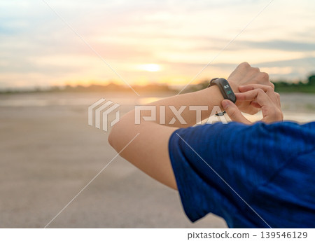 Woman touching smart fitness band after running, wearable device with heart rate monitor connected mobile app, healthy lifestyle. Activity tracking, workout performance and digital fitness technology. 139546129