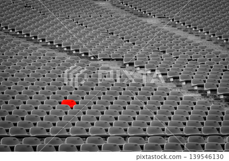 Outstanding empty red plastic seats in football stadium with rows of unoccupied chairs at outdoor soccer arena, reserved seating concept during match preparation. Sport venue infrastructure. Outstanding empty red plastic seats in football stadium with rows of unoccupied chairs at outdoor soccer arena, reserved seating concept during match preparation. Sport venue infrastructure. 139546130