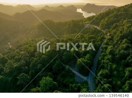 Landscape of green mountains with curve highway road and lake in the morning. Nature landscape. Watershed forest. Water and forest sustainability concept. Aerial view of mountain with green trees. Landscape of green mountains with curve highway road and lake in the morning. Nature landscape. Watershed forest. Water and forest sustainability concept. Aerial view of mountain with green trees. 139546140
