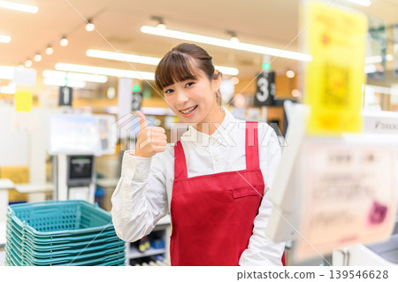 A woman working at super cash register A woman working at super cash register 139546628