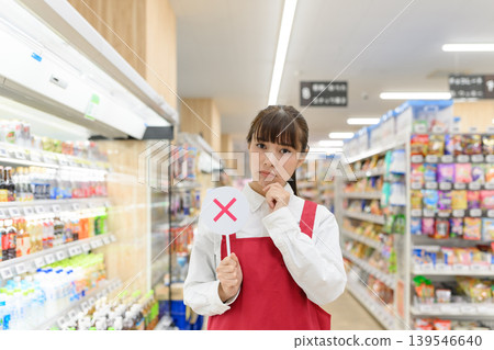The store clerk holds the wrong tag. The store clerk holds the wrong tag. 139546640