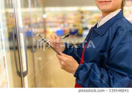 A store employee inspecting the supermarket A store employee inspecting the supermarket 139546641