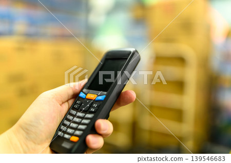 Hand holding a handheld terminal 139546683