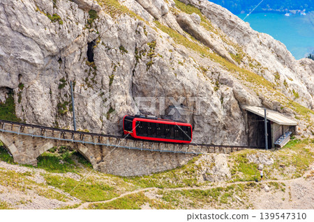 Cogwheel train climbing to the top of Mount Pilatus in Canton Lucerne, Switzerland. World's steepest cogwheel railway Cogwheel train climbing to the top of Mount Pilatus in Canton Lucerne, Switzerland. World's steepest cogwheel railway 139547310