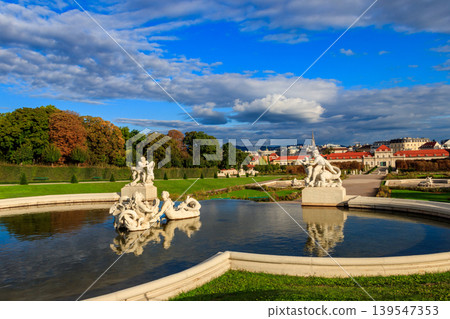 Fountain sculptures in Belvedere Gardens with Lower Belvedere in Vienna, Austria Fountain sculptures in Belvedere Gardens with Lower Belvedere in Vienna, Austria 139547353