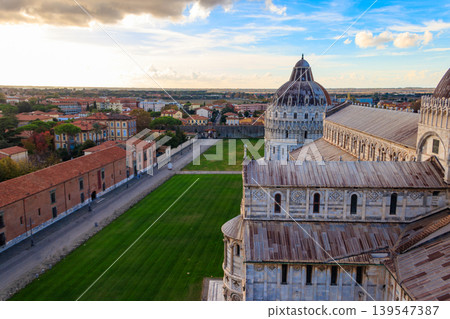 View of Pisa Cathedral (Cathedral of the Assumption of Mary) and the Pisa Baptistery of St. John from the Leaning tower in Pisa, Italy View of Pisa Cathedral (Cathedral of the Assumption of Mary) and the Pisa Baptistery of St. John from the Leaning tower in Pisa, Italy 139547387