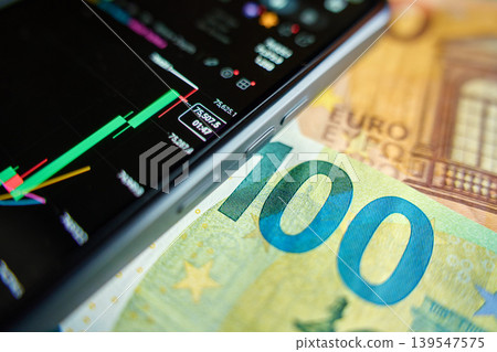 Smartphone with stock market chart on 100 euro banknote 139547575