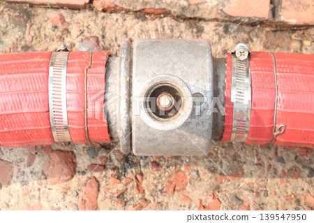 Red colored fire hose equipped with a Storz aluminum coupling, stainless steel clamp Red colored fire hose equipped with a Storz aluminum coupling, stainless steel clamp 139547950