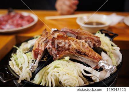 Lamb chops ready to eat on a Genghis Khan hot pot Lamb chops ready to eat on a Genghis Khan hot pot 139548323