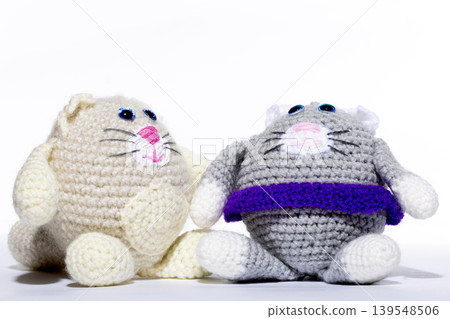 Knitted white cat on a white background Knitted white cat on a white background 139548506