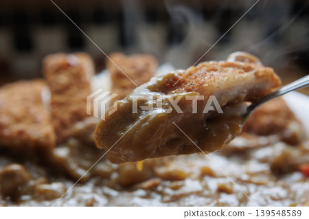 Chicken cutlet curry served on a spoon Chicken cutlet curry served on a spoon 139548589