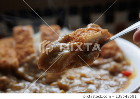 A steaming chicken cutlet curry served on a spoon A steaming chicken cutlet curry served on a spoon 139548591