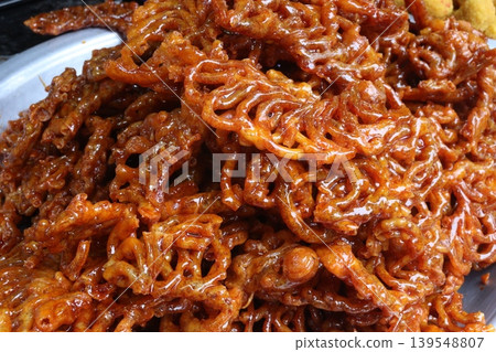 Jalebi is a common sweet snack in the Indian subcontinent Jalebi is a common sweet snack in the Indian subcontinent 139548807