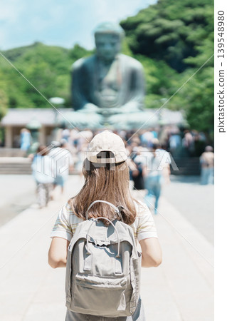 Woman tourist Visiting in Kamakura, Kanagawa prefecture , Japan. happy Traveler sightseeing the Great Buddha statue. Landmark and popular for tourists attraction near Tokyo. Travel and Vacation Woman tourist Visiting in Kamakura, Kanagawa prefecture , Japan. happy Traveler sightseeing the Great Buddha statue. Landmark and popular for tourists attraction near Tokyo. Travel and Vacation 139548980