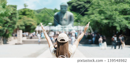 Woman tourist Visiting in Kamakura, Kanagawa prefecture , Japan. happy Traveler sightseeing the Great Buddha statue. Landmark and popular for tourists attraction near Tokyo. Travel and Vacation Woman tourist Visiting in Kamakura, Kanagawa prefecture , Japan. happy Traveler sightseeing the Great Buddha statue. Landmark and popular for tourists attraction near Tokyo. Travel and Vacation 139548982