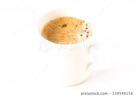 Image of a person relaxing while drinking a cafe latte, a coffee made from espresso and milk Image of a person relaxing while drinking a cafe latte, a coffee made from espresso and milk 139549158
