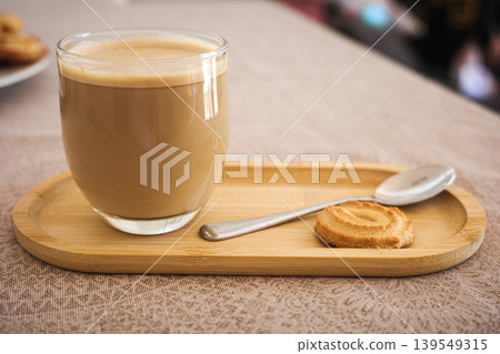 Glass Of Coffee With Cookie On Wooden Tray Glass Of Coffee With Cookie On Wooden Tray 139549315