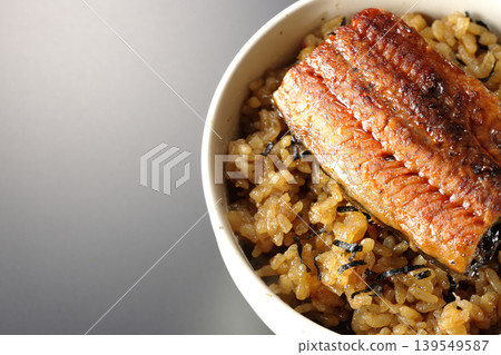 一張迷你鰻魚飯碗的照片，單獨擺放在黑色背景前。 139549587