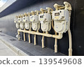 Residential gas meters installed in a row on the exterior wall of an apartment building in Japan. 139549608