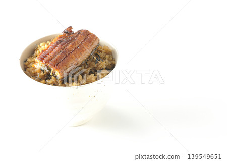 A mini eel rice bowl photographed alone against a white background. A mini eel rice bowl photographed alone against a white background. 139549651
