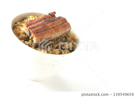 A mini eel rice bowl photographed alone against a white background. A mini eel rice bowl photographed alone against a white background. 139549659