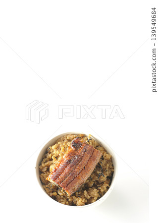 A mini eel rice bowl photographed alone against a white background. A mini eel rice bowl photographed alone against a white background. 139549684