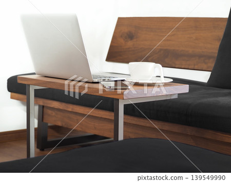 Image of working from home on a laptop in the living room. Image of working from home on a laptop in the living room. 139549990
