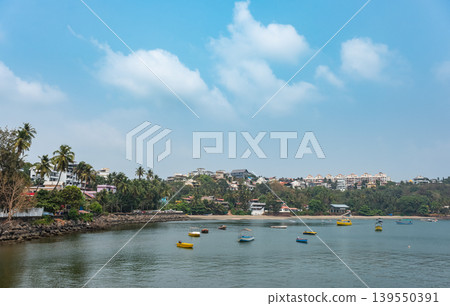 Boats sailing at Dona Paula viewpoint in Goa. Summer landscape with bay and coastal residential area Boats sailing at Dona Paula viewpoint in Goa. Summer landscape with bay and coastal residential area 139550391