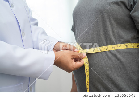 Asian woman with fat belly big size overweight and obesity with measure tape. Asian woman with fat belly big size overweight and obesity with measure tape. 139550545
