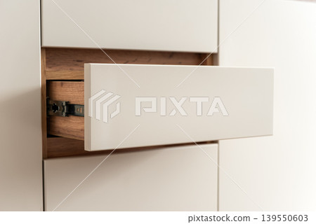 Modern kitchen cabinet drawer partially open Modern kitchen cabinet drawer partially open 139550603