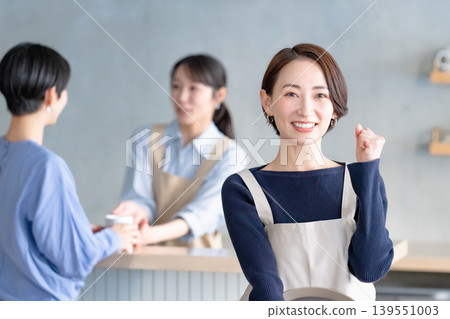 A woman working in a cafe A woman working in a cafe 139551003