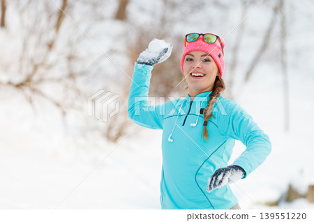 Girl playing games in snow Girl playing games in snow 139551220