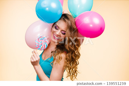 Woman with colorful balloons and lollipop Woman with colorful balloons and lollipop 139551239