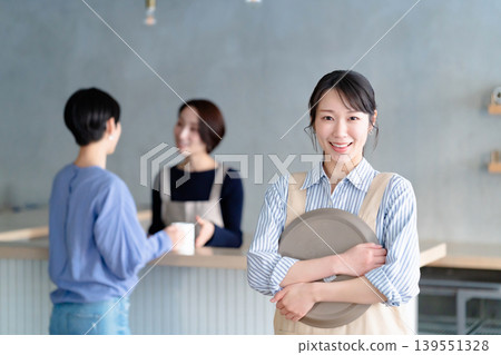A woman working in a cafe A woman working in a cafe 139551328