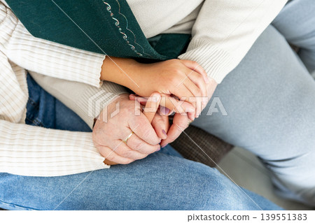 Elderly grandmother and young granddaughter hands, symbol of support and love. Elderly grandmother and young granddaughter hands, symbol of support and love. 139551383