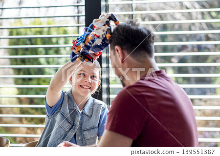 Father teaching daughter robotics at home while homeschooling with educational toy. 139551387