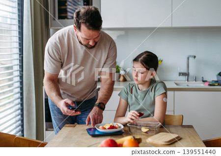 Parent helping diabetic daughter understand nutrition and sugar content. Parent helping diabetic daughter understand nutrition and sugar content. 139551440