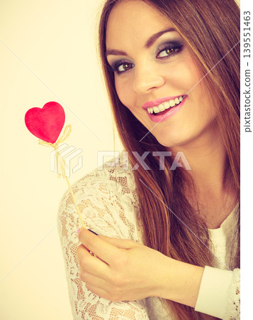 Beautiful woman holding heart shaped hand stick 139551463
