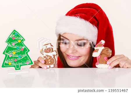 Woman santa claus hat with gingerbread cookies. Christmas Woman santa claus hat with gingerbread cookies. Christmas 139551467