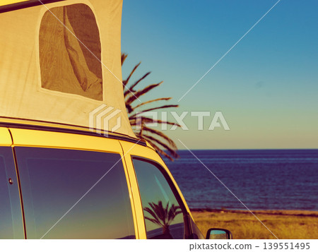 Camper van with tent on roof on beach Camper van with tent on roof on beach 139551495