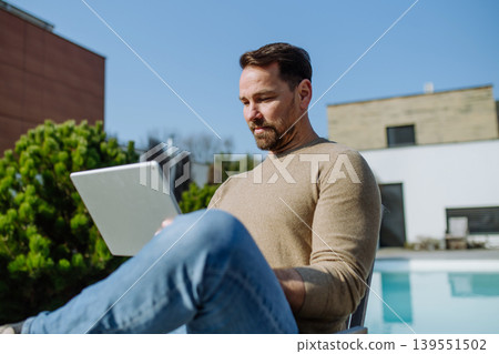 Man making online order or working from home on terrace. 139551502