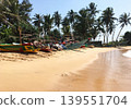 Fishing boats on a sandy beach 139551704