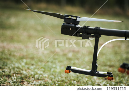 Close up of spray nozzles on agricultural drone. Dron spraying crops, distribute pesticides, herbicides and fertilizers efficiently and precisely. Modern farming. Close up of spray nozzles on agricultural drone. Dron spraying crops, distribute pesticides, herbicides and fertilizers efficiently and precisely. Modern farming. 139551735