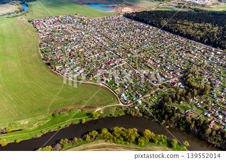 Dense dacha development near the river, view from a great height Dense dacha development near the river, view from a great height 139552014