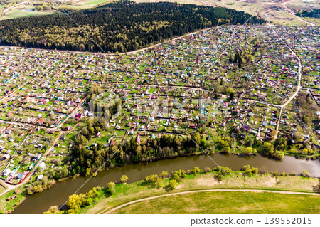 Dense dacha development near the river, view from a great height Dense dacha development near the river, view from a great height 139552015