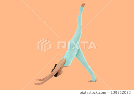 Yoga session features a person in a downward dog position 139552083