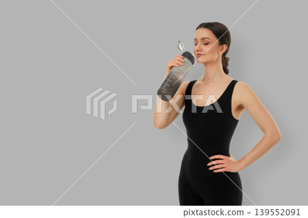 Yoga activity in a studio with a fitness model drinking water Yoga activity in a studio with a fitness model drinking water 139552091